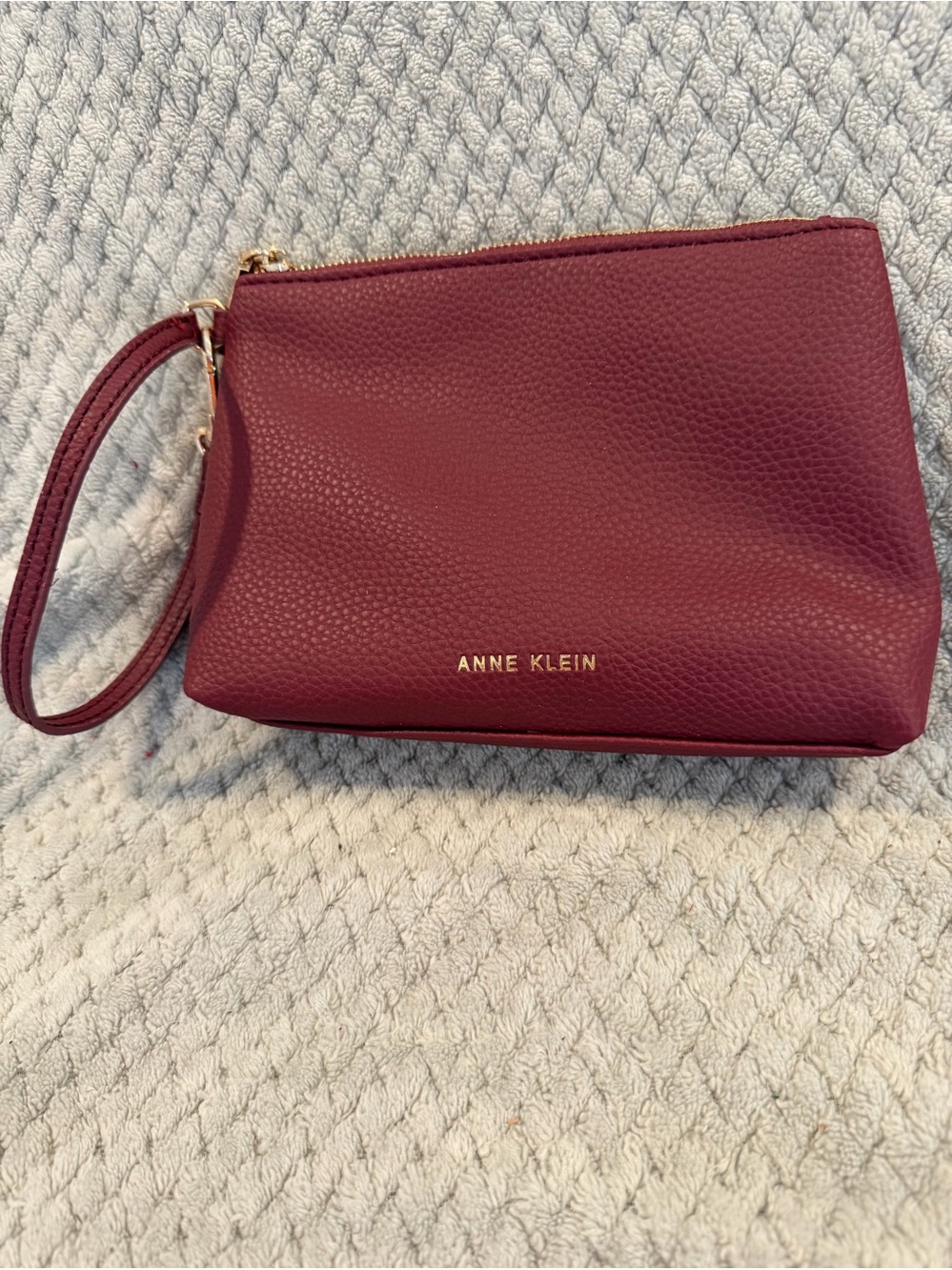 Maroon  pebbled leather Anne Klein wristlet pouch with a wrist strap Top Zipper.